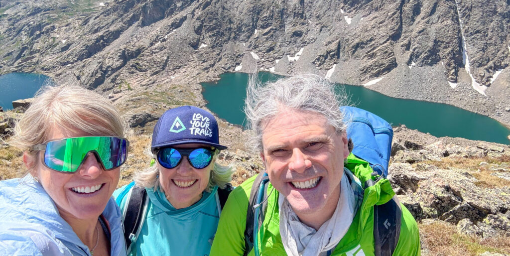Hikers at the summit of Mount of the Holy Cross in the Eagles Nest Wilderness Vail Valley wearing a Love Your Trails hat