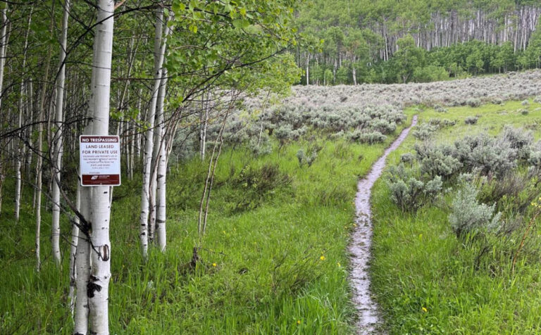 No trespassing sign marking a social trail through private land in Eagle County